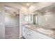 Modern bathroom with dual sinks, granite counters, and a large glass-enclosed shower at 6164 Violet Falls St # 44, North Las Vegas, NV 89081