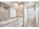 Bright bathroom with double sinks, granite countertops, and tiled floors at 6164 Violet Falls St # 44, North Las Vegas, NV 89081