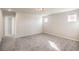 Bedroom with neutral walls, carpeted floors, and natural light from two windows at 6164 Violet Falls St # 44, North Las Vegas, NV 89081