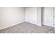 Neutral bedroom with closet doors and plush carpeting throughout at 6164 Violet Falls St # 44, North Las Vegas, NV 89081