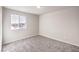 Bright bedroom with a large window and plush carpeting at 6164 Violet Falls St # 44, North Las Vegas, NV 89081