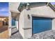 Modern home showcasing a blue garage door and door with complementary hardscaping and stucco at 6164 Violet Falls St # 44, North Las Vegas, NV 89081