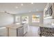 Bright kitchen and open concept living space with stainless appliances and tile flooring at 6164 Violet Falls St # 44, North Las Vegas, NV 89081