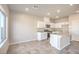 Open concept living area with a modern kitchen, white cabinets and tile floor at 6164 Violet Falls St # 44, North Las Vegas, NV 89081