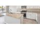 Modern kitchen with stainless steel appliances, granite counters, and central island at 6164 Violet Falls St # 44, North Las Vegas, NV 89081