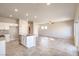 Open-concept living room features tile floors, recessed lighting, and a kitchen island at 6164 Violet Falls St # 44, North Las Vegas, NV 89081