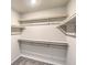 Spacious walk-in closet featuring multiple shelves and rods for organized storage at 6164 Violet Falls St # 44, North Las Vegas, NV 89081