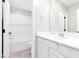 Bright bathroom with a large mirror, a white vanity, and a shower-tub combo at 6239 Milford Sound St, Las Vegas, NV 89148