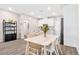Dining area with a wooden table, stylish chairs, and an open view of the modern kitchen at 6239 Milford Sound St, Las Vegas, NV 89148