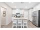 Modern kitchen featuring white cabinets, a granite countertop island, and stainless steel appliances at 6239 Milford Sound St, Las Vegas, NV 89148
