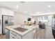 Open concept living area showcasing kitchen island, modern furniture, and lots of natural light at 6239 Milford Sound St, Las Vegas, NV 89148