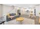 Cozy living room with a grey sofa, round wood table, and access to the open kitchen at 6239 Milford Sound St, Las Vegas, NV 89148