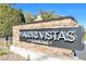 Stone and black monument sign displays community name, 