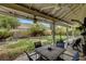 Enjoy the shade of the backyard's covered patio, perfect for outdoor dining and entertaining guests at 6304 Peppermill Dr, Las Vegas, NV 89146