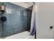 Modern bathroom with a bathtub and blue tiled walls, offering a clean and stylish space at 6304 Peppermill Dr, Las Vegas, NV 89146