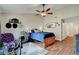 Cozy bedroom with wood floors, a ceiling fan, and a decorative theme at 6304 Peppermill Dr, Las Vegas, NV 89146