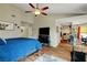 Spacious bedroom with wood floors, ceiling fan, and a well lit adjoining area at 6304 Peppermill Dr, Las Vegas, NV 89146