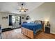 Bedroom with wood floors, ceiling fan, and a window with natural light at 6304 Peppermill Dr, Las Vegas, NV 89146