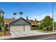 Charming single-story home with a well-manicured lawn, mature trees and a two car garage at 6304 Peppermill Dr, Las Vegas, NV 89146