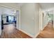 Hallway featuring hardwood flooring, leading to a bedroom, bathroom, and other living spaces at 6304 Peppermill Dr, Las Vegas, NV 89146