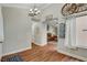 Hallway with a chandelier and wood floors leading to other parts of the home at 6304 Peppermill Dr, Las Vegas, NV 89146