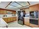 Kitchen with light tile counters, wood cabinets, overhead lighting, and stainless steel appliances at 6304 Peppermill Dr, Las Vegas, NV 89146