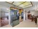 An open kitchen with stainless steel refrigerator, wood cabinets, and adjacent rooms at 6304 Peppermill Dr, Las Vegas, NV 89146