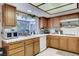 Well lit kitchen with a garden window, wood cabinets, and modern appliances at 6304 Peppermill Dr, Las Vegas, NV 89146