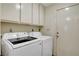 This house features a laundry room with a side-by-side washer and dryer and upper cabinets for storage at 6304 Peppermill Dr, Las Vegas, NV 89146