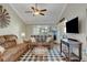 Vaulted living room featuring a ceiling fan, two sofas, and a black and white checkered rug at 6304 Peppermill Dr, Las Vegas, NV 89146