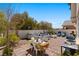 Charming backyard with a dining area, lounge seating, a fire pit, and string lights for cozy evenings at 6620 Macdoogle St, Las Vegas, NV 89166