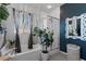 Bathroom featuring a soaking tub, glass-enclosed shower, and ample natural light, creating a spa-like retreat at 6620 Macdoogle St, Las Vegas, NV 89166