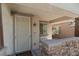 Inviting covered front porch with stone accents and decorative security door provides a warm welcome at 6620 Macdoogle St, Las Vegas, NV 89166