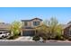 Charming two-story home features a stone facade, well-manicured landscaping, and a spacious two-car garage at 6620 Macdoogle St, Las Vegas, NV 89166