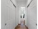 Hallway featuring white doors, neutral carpet, and recessed lighting, offering a clean and bright transition space at 6620 Macdoogle St, Las Vegas, NV 89166