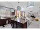 Open concept kitchen and living area with granite countertops and a view to the seating area at 6620 Macdoogle St, Las Vegas, NV 89166