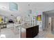 Open concept kitchen featuring an island with granite countertops and a view to the living area at 6620 Macdoogle St, Las Vegas, NV 89166
