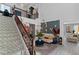 Bright living room with high ceilings, decorative stairway, and lots of natural light at 6620 Macdoogle St, Las Vegas, NV 89166