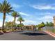 Gated community entrance with palm trees, manicured landscaping, and a well-maintained asphalt driveway at 6650 W Warm Springs Rd # 2173, Las Vegas, NV 89118