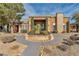 Beautiful single-story home with a stone chimney and professionally landscaped yard with desert rock and lush foliage at 6650 W Warm Springs Rd # 2173, Las Vegas, NV 89118