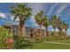 Well-maintained apartment buildings with palm trees, green lawns, and manicured landscaping enhance community appeal at 6650 W Warm Springs Rd # 2173, Las Vegas, NV 89118