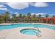 Resort-style community pool with a spa, palm trees, and cabanas, offering a luxurious outdoor experience at 6650 W Warm Springs Rd # 2173, Las Vegas, NV 89118