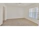 Spacious carpeted bedroom with natural light from the window and view into the doorway at 6800 E Lake Mead Blvd # 2050, Las Vegas, NV 89156
