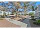 Exterior view of residential buildings with well maintained landscaping, walkway and large trees at 6800 E Lake Mead Blvd # 2050, Las Vegas, NV 89156
