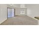 Open living room with balcony access and view, carpeted floors, and plenty of sunlight at 6800 E Lake Mead Blvd # 2050, Las Vegas, NV 89156