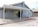 A covered back patio with a sliding glass door, perfect for outdoor relaxation at 7170 Mountain Moss Dr, Las Vegas, NV 89147