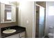 Bathroom featuring a vanity with a dark countertop and a shower with glass doors at 7170 Mountain Moss Dr, Las Vegas, NV 89147