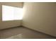 A bright bedroom featuring tile floors and a large window with blinds at 7170 Mountain Moss Dr, Las Vegas, NV 89147