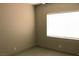 Bedroom featuring a neutral color palette, tile flooring, and natural light at 7170 Mountain Moss Dr, Las Vegas, NV 89147