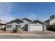 Charming single-story home featuring a well-maintained front yard and attached two-car garage at 7170 Mountain Moss Dr, Las Vegas, NV 89147